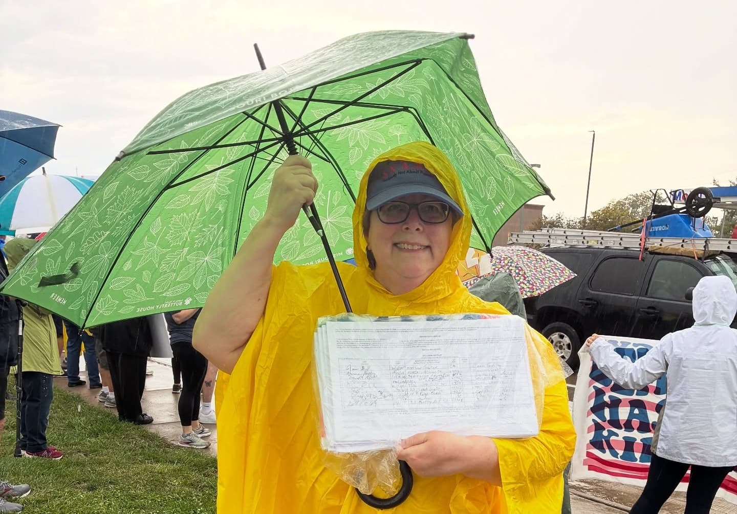 People Not Politicians Missouri - Signature gatherer in the rain with umbrella