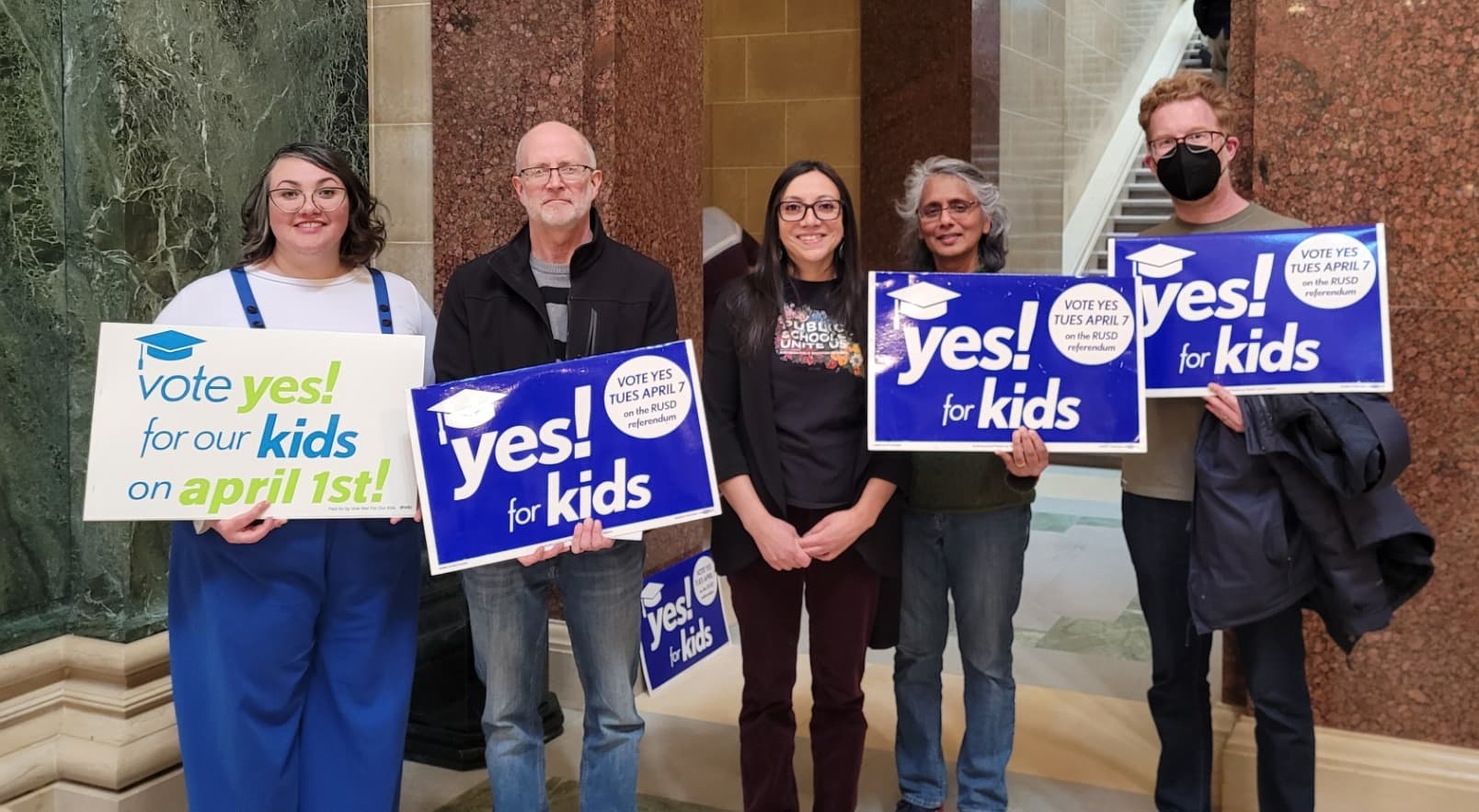 Vote Yes for Our Kids – Wisconsin – 2025-03-07 – Quintet – Ballot measure supporters holding campaign signs