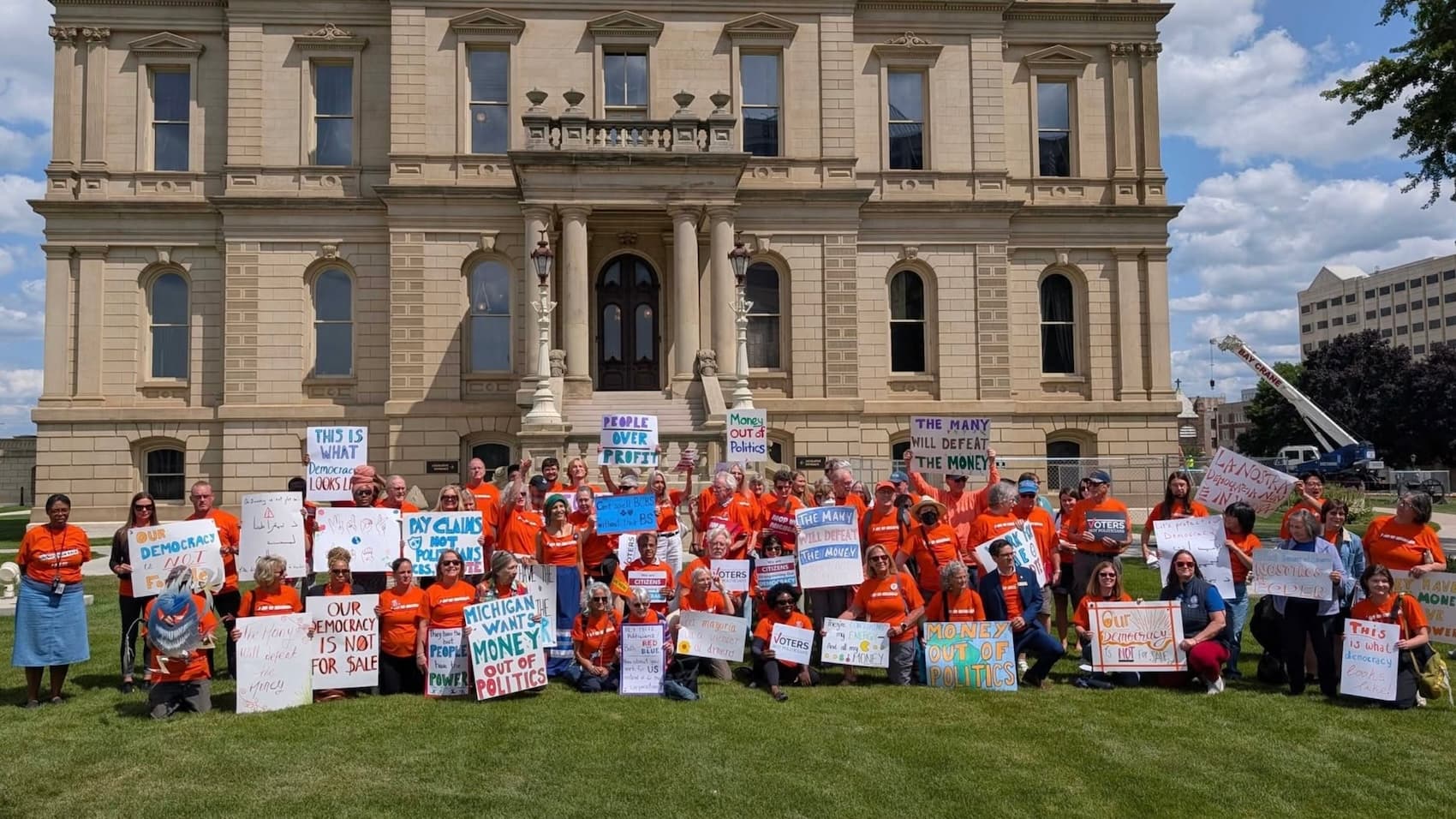 Photo: Michiganders for Money Out of Politics at the Michigan State Capitol last week, where their massive petition signature collection was approved, moving them a huge step closer to getting a money-out-of-politics ballot measure in front of voters in November.