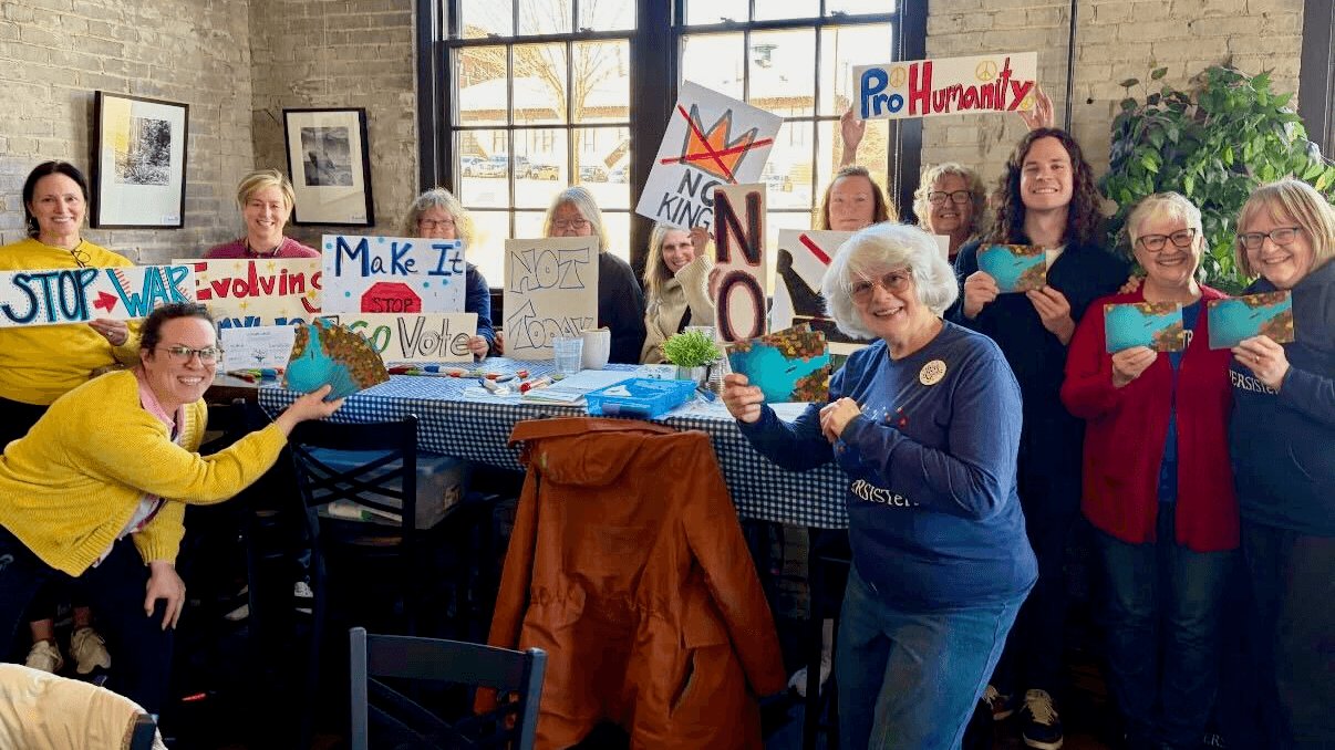 Photo: Wisconsin Conservation Voters writing postcards for Chris Taylor at No Kings 3.
