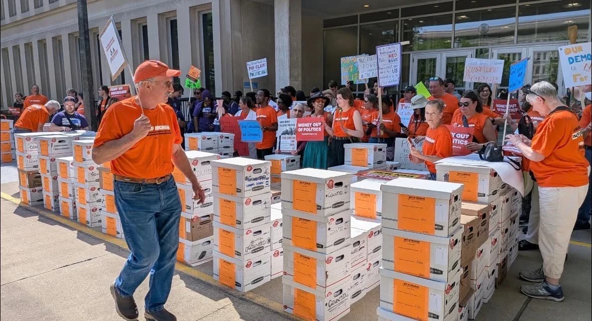 Photo: Michiganders for Money Out of Politics (MMOP) - Volunteers rallying with boxes of petitions.